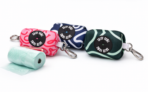 Four colourful pet poop bag dispensers with 'Salty Paws' labels on a white background